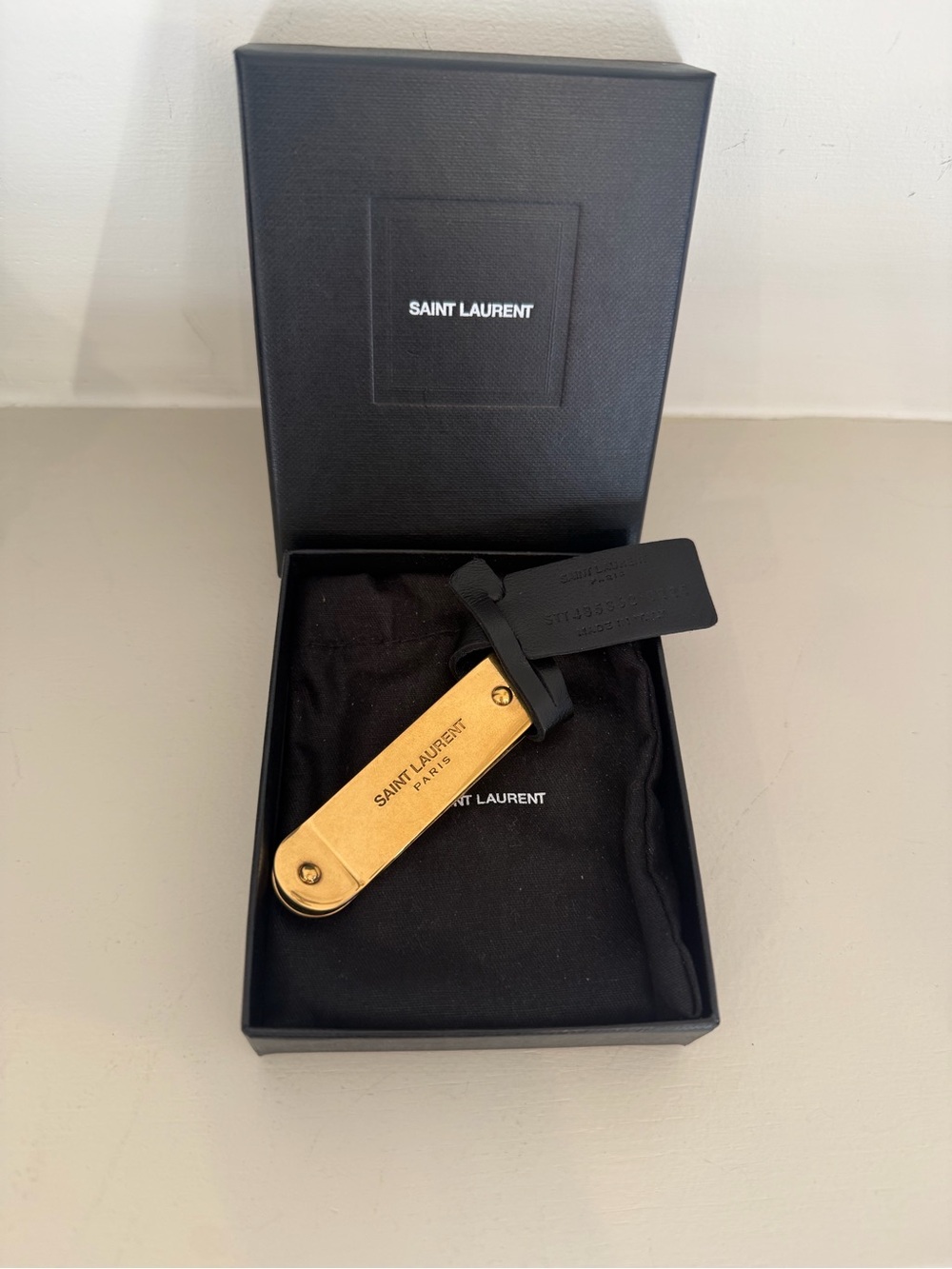 Saint Laurent Gold Money Clip with Black Leather Tag